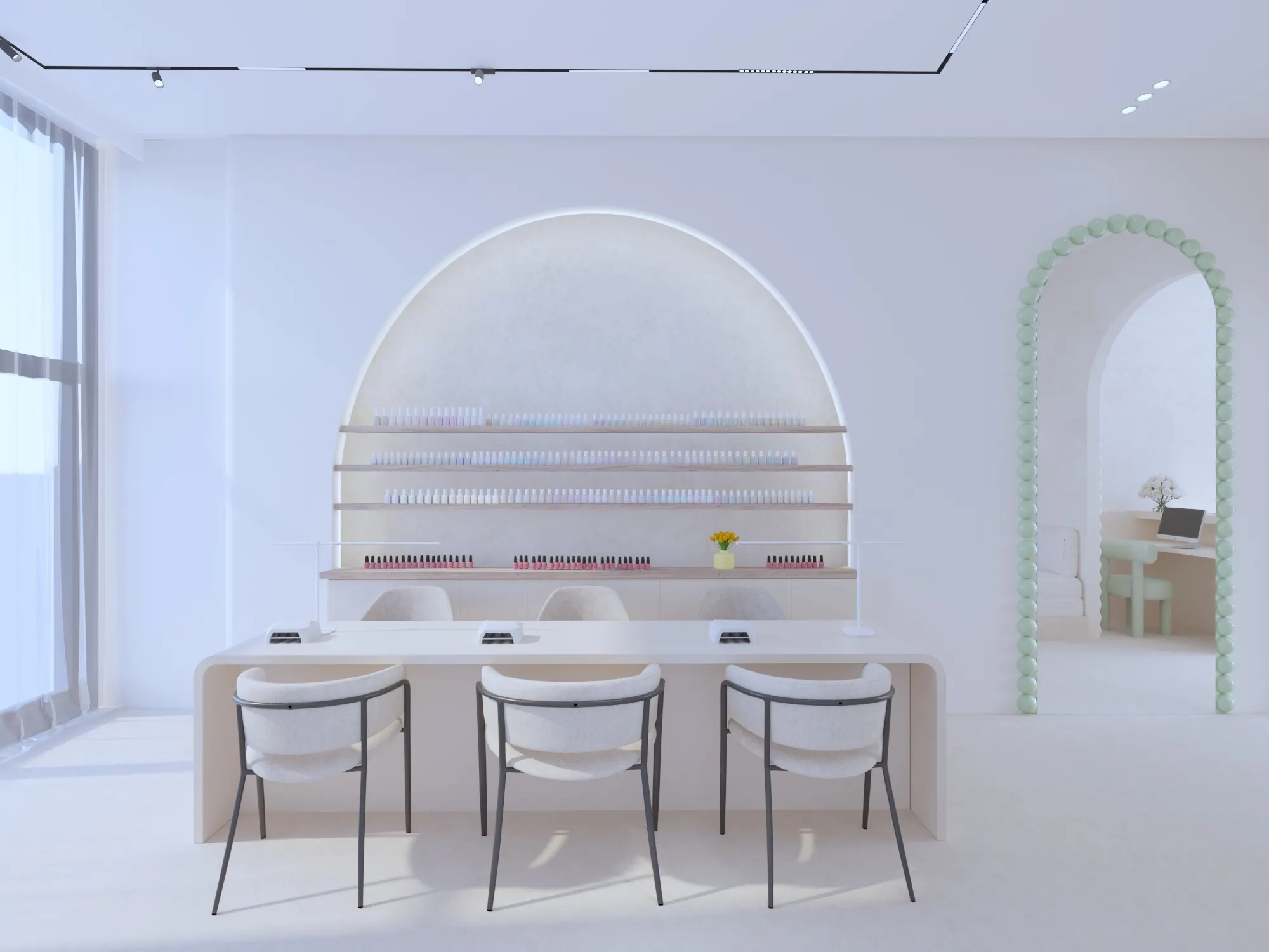 Manicure bar facing a lit arched shelf full of nail polish, with bouclé chairs and a sage green scalloped arch to one side